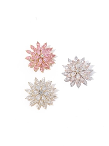Macro detail of rotating flower brooches with pink marquise-cut zircon petals