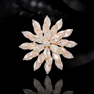 Detailed macro view of rotating pink zircon flower brooch with rose gold plating
