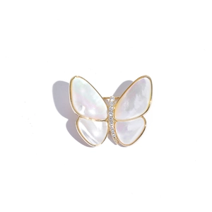 Detail of butterfly brooch featuring natural shell wings and elegant zircon body