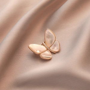 Elegant butterfly brooch with natural mother of pearl wings and zircon in rose gold