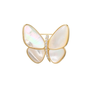 Macro shot of butterfly brooch with natural mother-of-pearl wings and cubic zirconia body