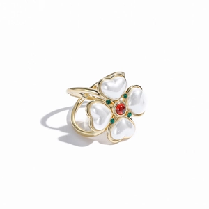 Detailed close-up of a vintage golden flower scarf clip with white heart-shaped petals