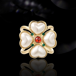 Elegant four-leaf flower brooch with heart pearls, ruby center, and emerald accents