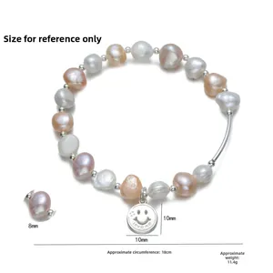 Macro detail of S925 silver smiley face charm and natural freshwater pearls on bracelet