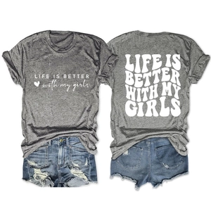Flat lay of grey graphic t-shirt with blue distressed denim shorts and white printing