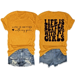 Detail of yellow cotton t-shirt with slogan and distressed blue denim shorts set