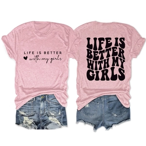 Flat lay detail of pink cotton t-shirt with Life Is Better slogan and ripped denim shorts