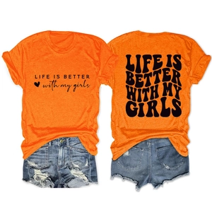Flat lay of orange slogan t-shirt with ripped denim shorts in American casual style