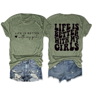 Detailed flat lay of olive green graphic t-shirt and distressed denim shorts outfit set