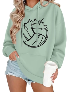 Detail of mint green hoodie with game day volleyball graphic and drawstring hood