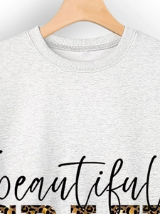 Detail of white cotton sweatshirt featuring beautiful leopard print lettering design