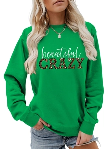 Detail of green crewneck sweatshirt featuring leopard print CRAZY letter design