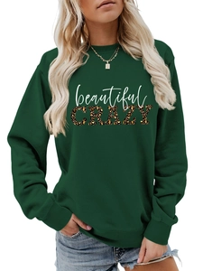 Detail of dark green crewneck sweatshirt with leopard print and beautiful CRAZY text