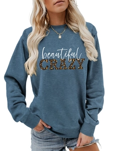 Detail of greyish-blue sweatshirt with leopard print CRAZY letter branding and ribbed cuffs
