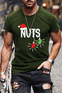 Close-up of Christmas themed NUTS print and festive lights on a dark green men's cotton t-shirt