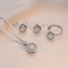Detailed set of silver jewelry with round cat eye stones and sparkling zircon pavé