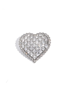 Close-up of heart-shaped brooch with pear-cut cubic zirconia in silver metal base