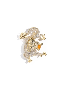 Detailed view of dragon brooch with micro-pave zircons and an orange bead centerpiece