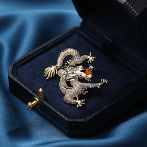 Exquisite golden dragon brooch with zircon inlay in a premium navy blue velvet jewelry box