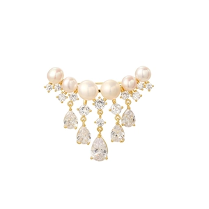 Detail of elegant gold pearl brooch with dangling teardrop zircons on white background