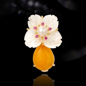 Elegant flower brooch with white shell petals, pearl center and large yellow amber drop