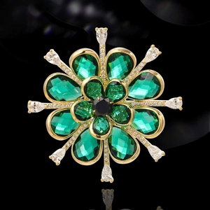 Elegant emerald green flower brooch with zircon stones and golden metal finish