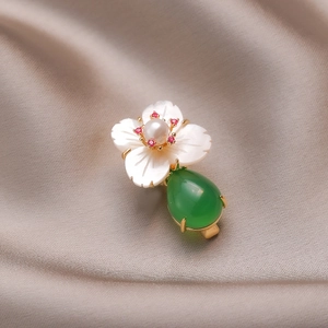 Vintage gold brooch with white shell flower, pearl center and green teardrop gemstone
