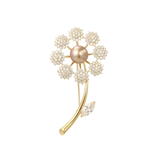 Detail of flower brooch with golden champagne pearl and sparkling zircon petals