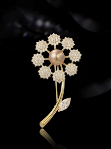 Macro detail of pearl brooch with cubic zirconia petals and marquise leaf on black background