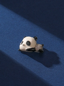 Macro shot of cute panda brooch with black and white enamel and sparkling rhinestones