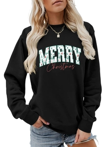 Close-up of Merry Christmas graphic and green tree pattern on black crewneck sweatshirt