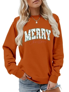 Detail of pumpkin orange Merry Christmas sweatshirt with festive tree patterns and ribbing