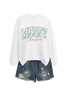 White Christmas sweatshirt with tree graphic and distressed denim shorts flat lay