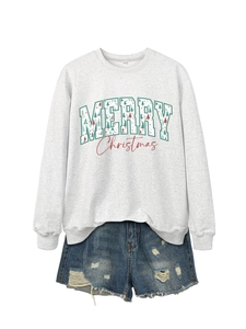 Flat lay detail of a light grey Merry Christmas sweatshirt and frayed denim shorts