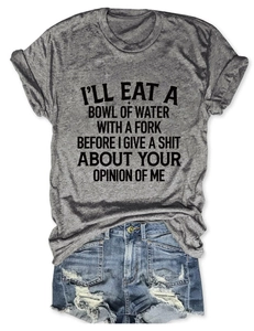 Flat lay of a grey slogan T-shirt paired with distressed light blue denim shorts