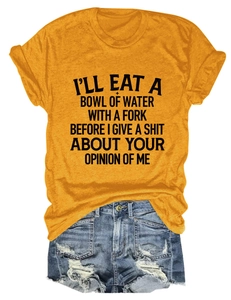 Detail of mustard yellow cotton T-shirt with black text print paired with denim shorts