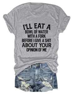 Detail of grey crewneck T-shirt with black slogan and ripped denim shorts with frayed hems