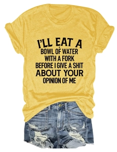 Flat lay of yellow slogan T-shirt paired with distressed denim shorts on white background