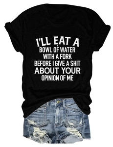 Detailed view of black slogan t-shirt and distressed blue denim shorts flat lay