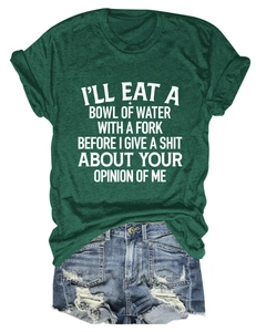 Flat lay of a dark green slogan t-shirt paired with distressed blue denim shorts