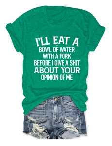 Flat lay of bright green cotton T-shirt with white slogan and distressed denim shorts