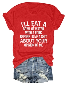 Close-up of red short sleeve T-shirt with white quote print and ripped denim shorts