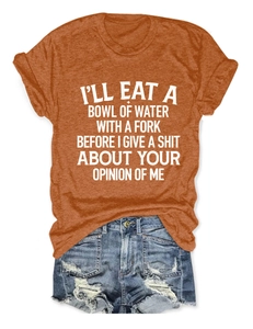 Flat lay of an orange crew neck t-shirt and light blue distressed denim shorts set