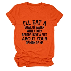 Detail of orange crew neck T-shirt featuring bold black typography and soft cotton texture