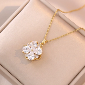 Elegant gold spinning flower necklace with teardrop zircon petals in a jewelry box