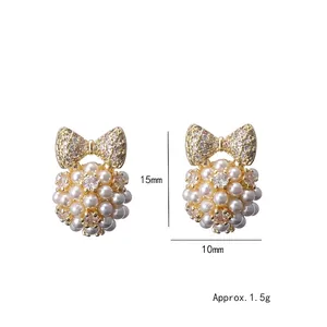 Elegant gold bow earrings with micro-set zircons and round pearl cluster drops