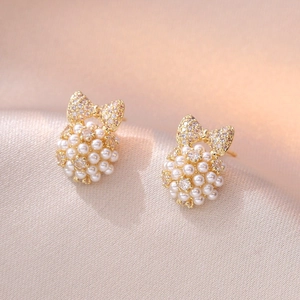 Elegant bow knot stud earrings with cubic zirconia and round white pearl clusters