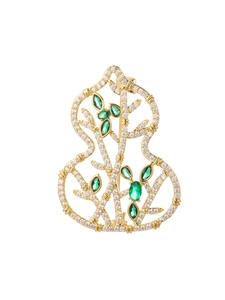 Detailed close-up of a hollow gourd brooch with gold finish and inlaid green gemstones