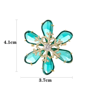 Sparkling emerald green snowflake brooch pin for women with crystal details in gold