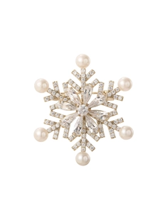 Detail of snowflake brooch with gold base, white pearls and sparkling cubic zirconia